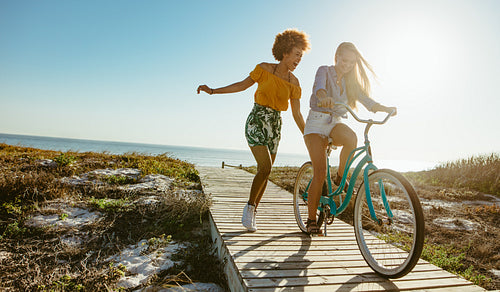 Friends enjoying themselves with a bicycle