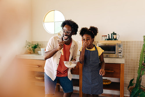 Father and daughter enjoying family baking time in the kitchen