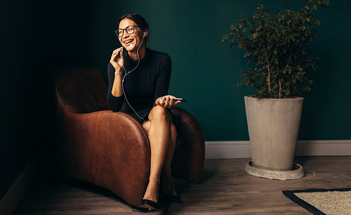 Smiling young businesswoman talking on phone