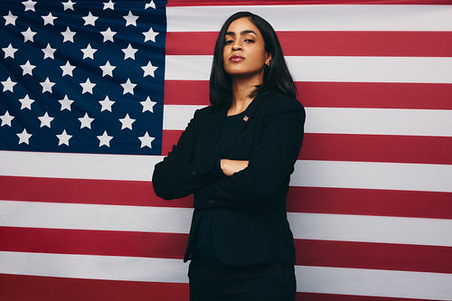 Congresswoman standing against an American flag
