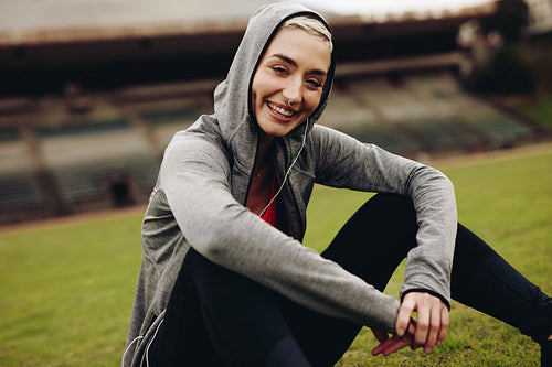 Female athlete relaxing on running track