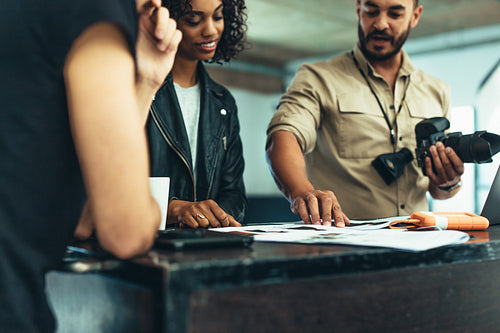 Photographer reviewing the photo shoot with his team