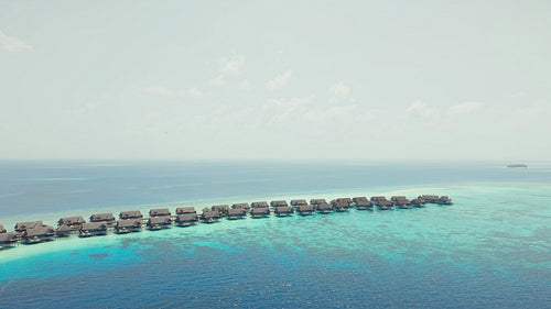 Breathtaking aerial drone view of overwater bungalows in tropical island paradise