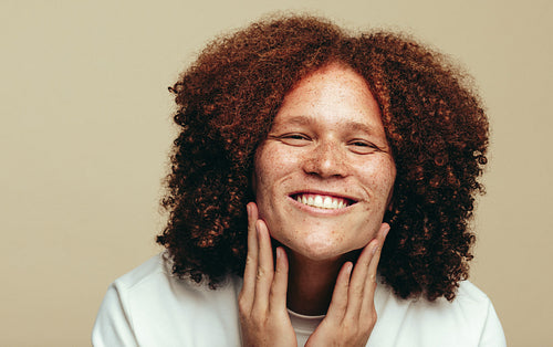 Man embracing his natural beauty and using a skincare product