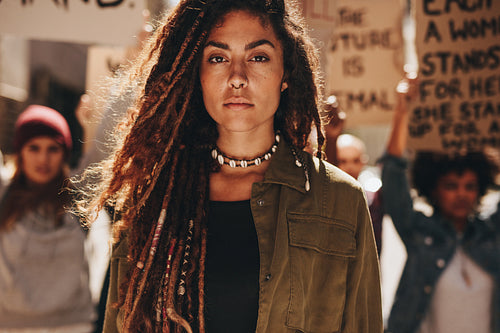 Woman in front of demonstrators on road