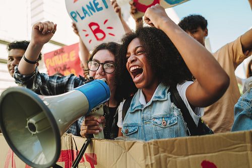 Youth climate activists protesting with a megaphone