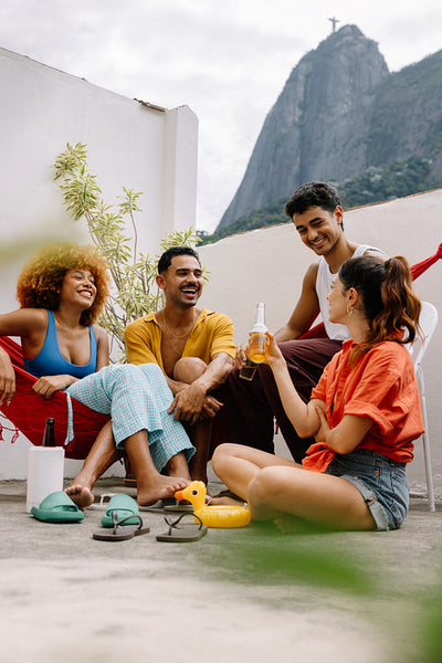 Group of young adults relaxing outdoors with Christ the Redeemer in view