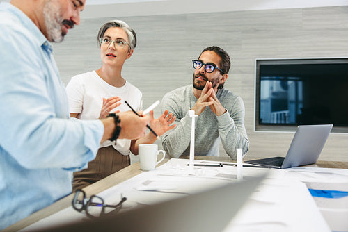 Group of design professionals having a discussion in an office