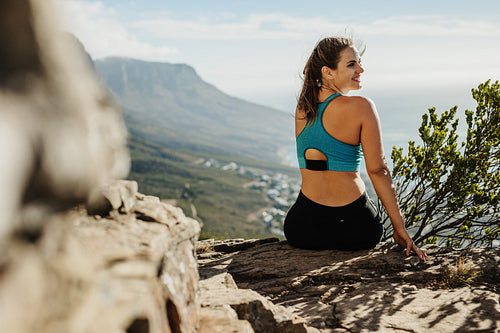 Woman hiker relaxing in the cliff