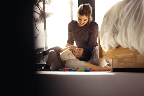 Loving mother and son playing together