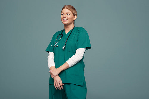 Successful female dcotor smiling cheerfully in a studio