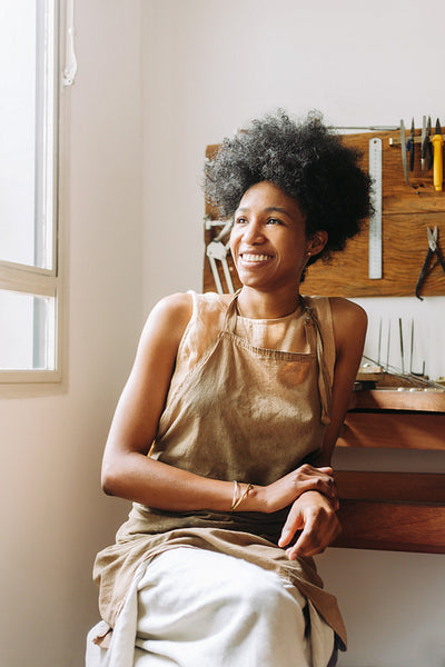 Happy female jeweler in workshop