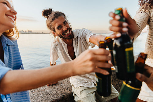 Young friends enjoying a summer evening by the waterfront in Brazil