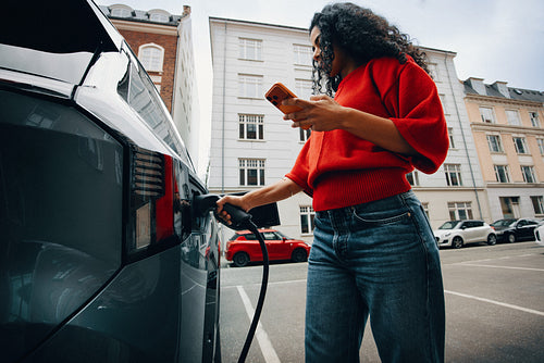 Travel in the city feels easier as a woman handles electric charging