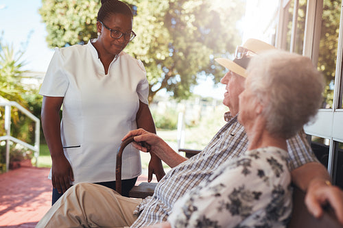 Carer looking after an elderly couple