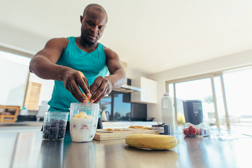 Man preparing breakfast in kitchen