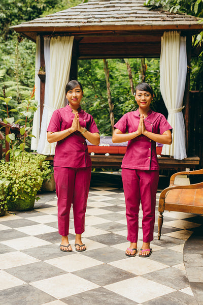 Two women massage therapist welcoming guest at spa,