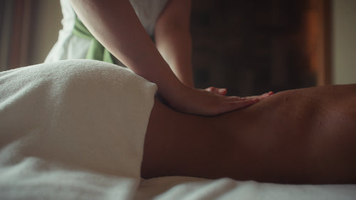 Luxury massage close-up with therapist’s hands gliding and camera tracking movement
