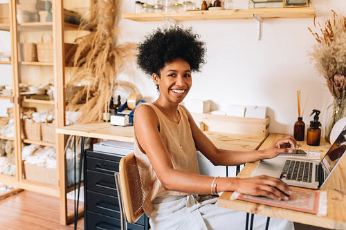 Young jewelry artisian with laptop