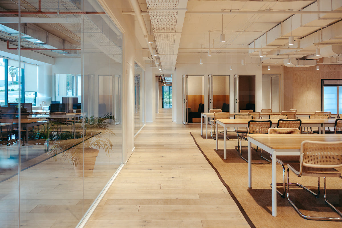 Modern coworking office space interior with open seating and glass par ...