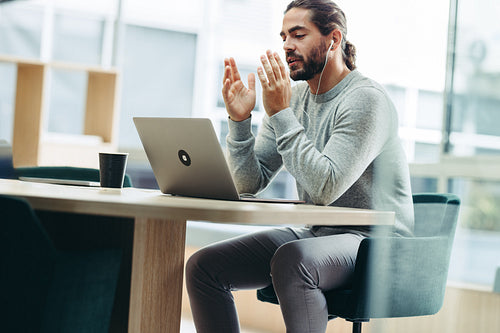 Young businessman speaking during a virtual meeting