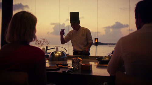 Golden tropical sunset over a luxurious resort beach with calm ocean waters