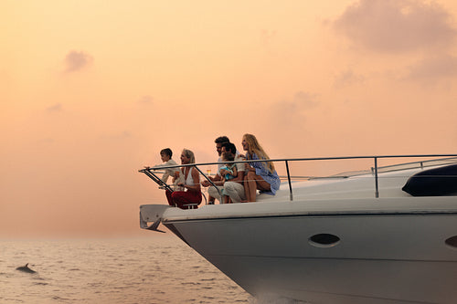 Luxury dolphin-watching cruise at sunset on a family vacation