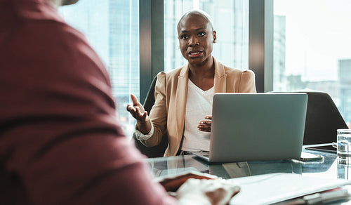 Business woman discussing work with a colleague in modern office
