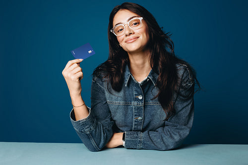Her confident woman portrait shows a credit card for financial service themes