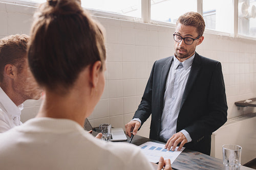 Businessman explaining new business ideas to coworker