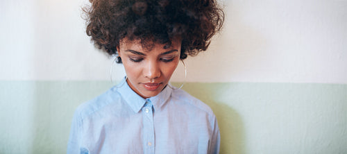 Pensive young woman looking down