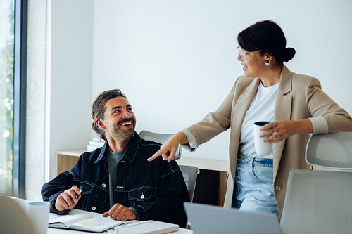 Business talk in office as colleagues smile and chat