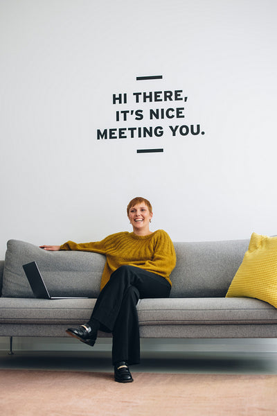 Successful freelancer sitting on sofa in office
