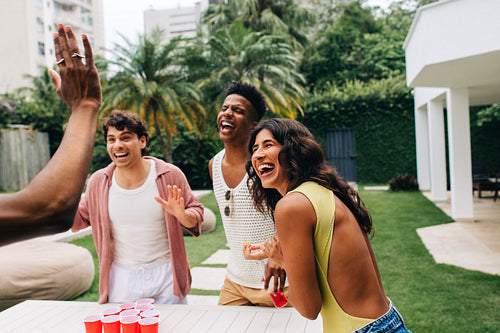 Beer pong game with friends outdoors