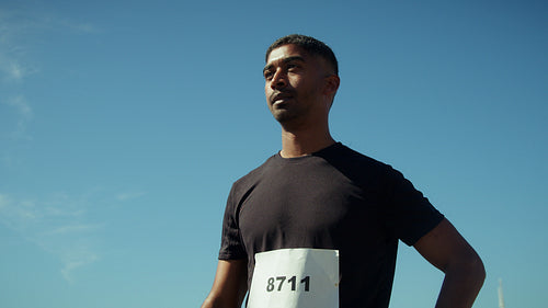 Man puts on sunglasses before race