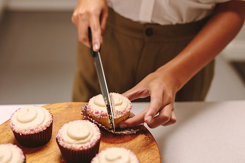 Chef cutting a cupcake