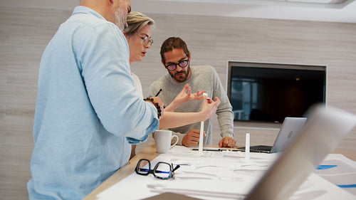 Female engineer working with her male colleagues on mechanical design for wind energy