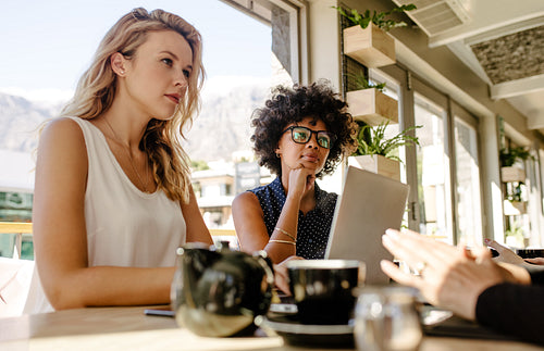Multi-ethnic businesswomen meeting in coffee shop