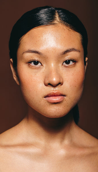 Confidence and radiance: Asian beauty looks at the camera in a studio