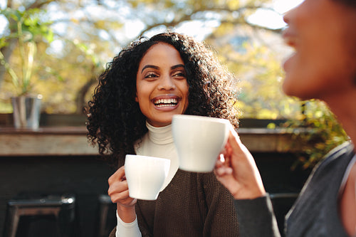 Two women drinking coffee at a coffee shop