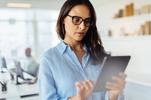 Business woman using a tablet pc in an office