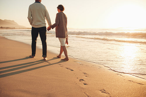 Senior couple walking along the sea shore