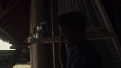 Waiter setting breakfast table at overwater villa in the Maldives