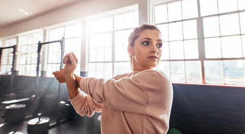 Young woman training in gymnasium.