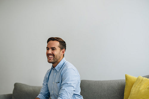 Confident businessman sitting on sofa