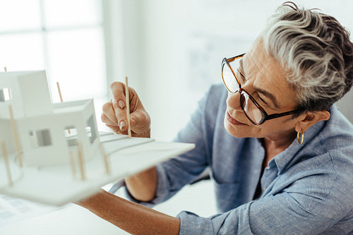 Women in STEM: Female design architect working on a 3D model for a house construction