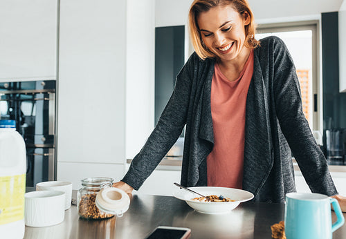 Woman at dining table with breakfast