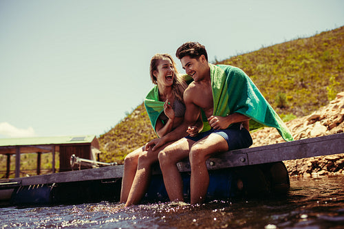 Couple enjoying on pier at the lake