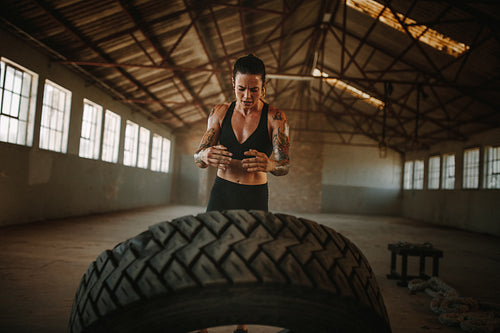 Fit woman doing tire flip workout