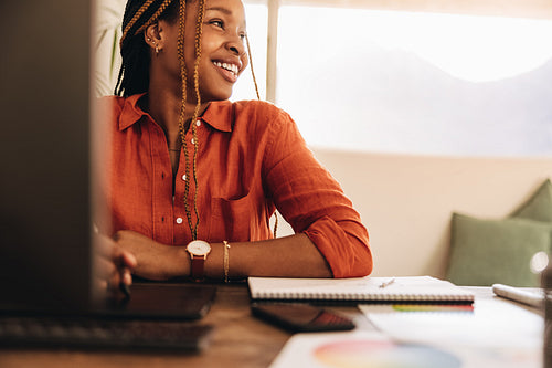 Female designer smiling in her office